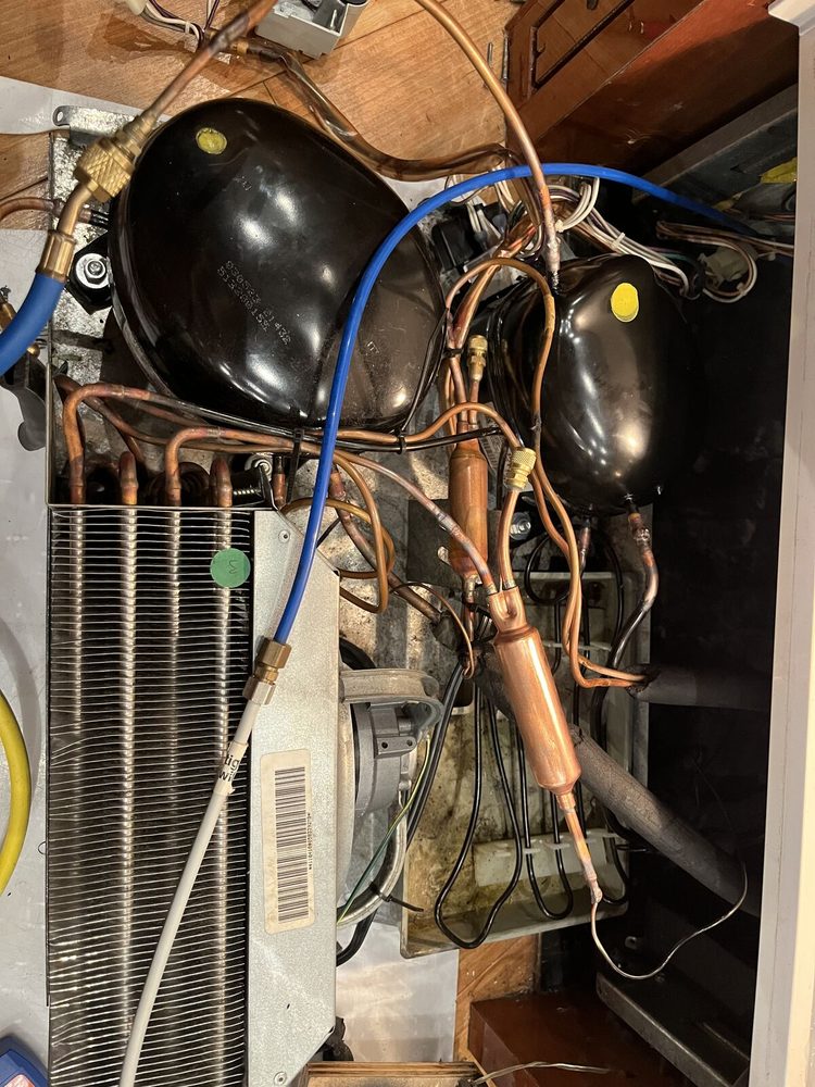 Machine compartment of a dual-compressor built-in refrigerator during a compressor replacement in Wesley Chapel 33543