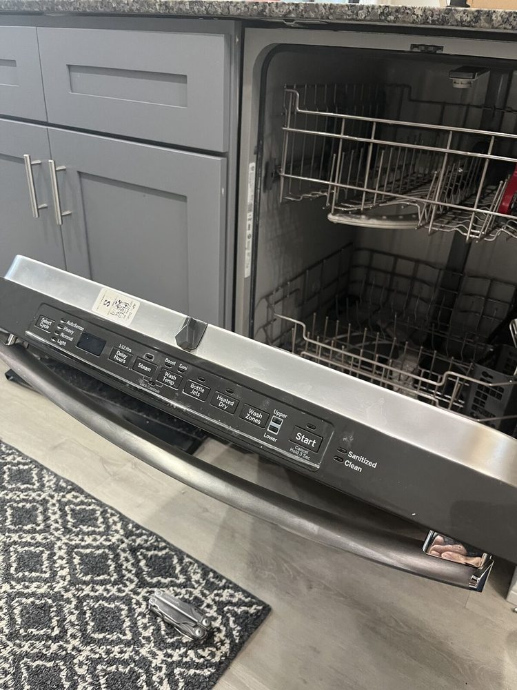 Dishwasher control panel exposed along the top edge of the open door during a diagnostic in Tampa