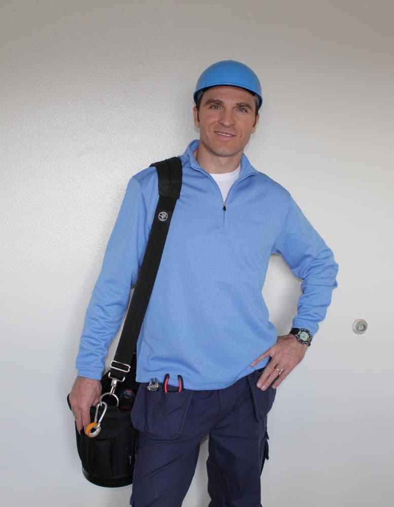Nick, technician, standing full length with his tool bag