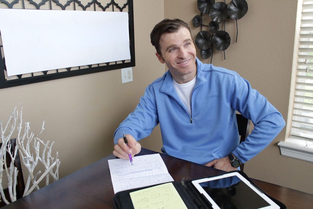 Owner-technician writing up the repair estimate at the customer's table
