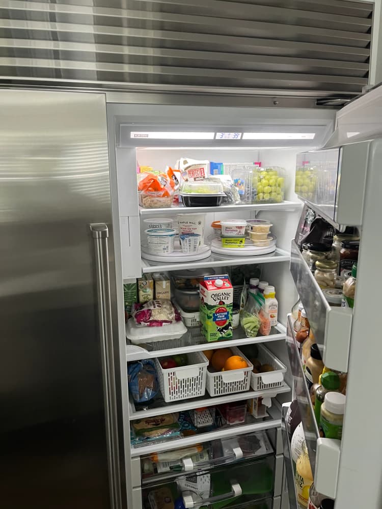 Sub-Zero built-in refrigerator open and fully stocked, holding temperature after repair on Bay to Bay Blvd, South Tampa, FL 33611