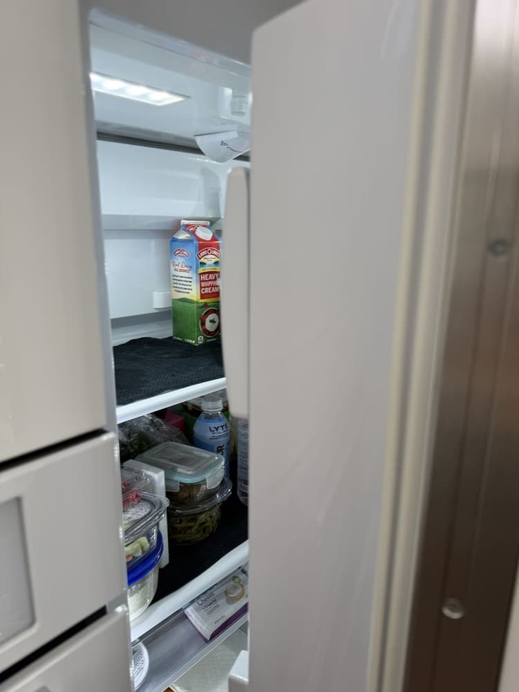 Inside a Viking built-in refrigerator after service, shelves stocked and cooling restored