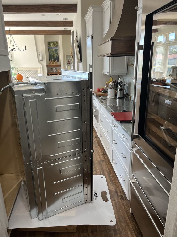 Built-in wall oven pulled out of its cabinet for access during a no-heat repair