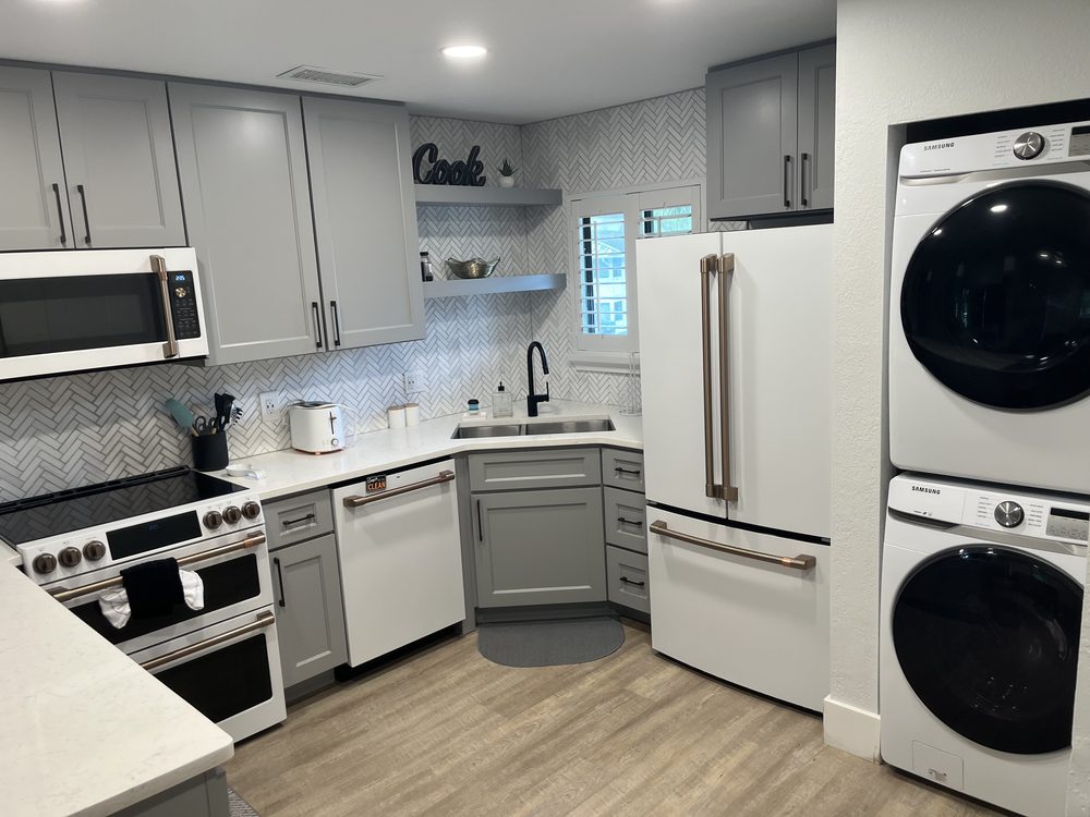 Zephyrhills kitchen with a built-in dishwasher beside the sink cabinet